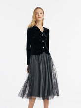 A lady wears a gray tulle skirt.